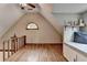 A-frame loft with hardwood floors, bench seat, and arched window at 1365 Lower Creighton Rd, Cumming, GA 30028
