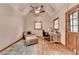 Comfortable office with wood flooring, wood door, ceiling fan, desk, and sitting area at 1365 Lower Creighton Rd, Cumming, GA 30028