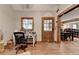 Home office space with hardwood floors, natural light, with view into the kitchen and dining area at 1365 Lower Creighton Rd, Cumming, GA 30028