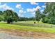 Picturesque property with fencing, mature trees, and a distant view of the home at 1365 Lower Creighton Rd, Cumming, GA 30028