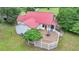 An elevated shot of the home's rear exterior features a large wooden deck with seating at 1365 Lower Creighton Rd, Cumming, GA 30028