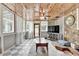 Relaxing sunroom showcasing wood ceilings, stone accents and walls of windows at 1365 Lower Creighton Rd, Cumming, GA 30028