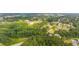A beautiful aerial view of a tree-filled landscape, in a charming neighborhood at 157 Shadburn Ferry Rd, Buford, GA 30518