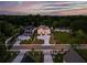 Aerial shot of luxury homes in a tree-lined neighborhood with a stunning sunset backdrop at 157 Shadburn Ferry Rd, Buford, GA 30518