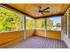 Cozy back porch featuring wood plank ceilings and screened windows, perfect for enjoying the outdoors at 157 Shadburn Ferry Rd, Buford, GA 30518