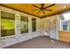Outdoor back porch with brick columns, wood ceilings, and views to the greenery beyond at 157 Shadburn Ferry Rd, Buford, GA 30518