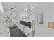 Luxury bathroom with a walk-in shower, soaking tub, and elegant modern chandelier above it at 157 Shadburn Ferry Rd, Buford, GA 30518