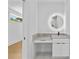 Modern bathroom vanity with sleek cabinets, a stone countertop, and an illuminated round mirror at 157 Shadburn Ferry Rd, Buford, GA 30518