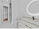 Bathroom featuring double vanity, round mirror, and glass-enclosed shower at 157 Shadburn Ferry Rd, Buford, GA 30518