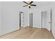 Bright, open bedroom with wood floors and a ceiling fan at 157 Shadburn Ferry Rd, Buford, GA 30518