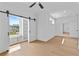 Bright bedroom features a ceiling fan, sleek sliding barn doors, and a built-in window seat with storage at 157 Shadburn Ferry Rd, Buford, GA 30518