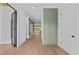 Bright entryway with light hardwood floors and modern sage green accent wall at 157 Shadburn Ferry Rd, Buford, GA 30518