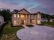 Striking brick exterior with grand entrance, circular driveway, and attached two-car garage at 157 Shadburn Ferry Rd, Buford, GA 30518