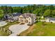 Beautiful exterior of a brick house with a circular driveway and well-maintained landscaping at 157 Shadburn Ferry Rd, Buford, GA 30518