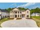 Striking brick exterior with grand entrance, circular driveway, and attached two-car garage at 157 Shadburn Ferry Rd, Buford, GA 30518