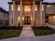 Charming brick home featuring a grand entrance with stately pillars and manicured landscaping at 157 Shadburn Ferry Rd, Buford, GA 30518