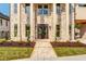 Charming brick home featuring a grand entrance with stately pillars and manicured landscaping at 157 Shadburn Ferry Rd, Buford, GA 30518