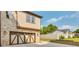 Side exterior of a home with a two-car garage and concrete driveway leading to the street at 157 Shadburn Ferry Rd, Buford, GA 30518