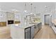 Gourmet kitchen with large island, stainless steel appliances, and cozy fireplace at 157 Shadburn Ferry Rd, Buford, GA 30518