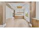 Open living room with wood floors, beams, modern light fixture, and a view of the entry at 157 Shadburn Ferry Rd, Buford, GA 30518