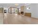 Open living room with wood floors, fireplace, and view of the modern light fixture at 157 Shadburn Ferry Rd, Buford, GA 30518