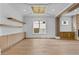 Bright living room with wood floors, white walls, built in storage, and large window at 157 Shadburn Ferry Rd, Buford, GA 30518