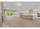 Open floor plan living room and kitchen with expansive wood floors and modern design at 157 Shadburn Ferry Rd, Buford, GA 30518