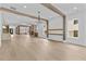 Spacious living room with wood floors, beams, and view to the kitchen and living spaces at 157 Shadburn Ferry Rd, Buford, GA 30518