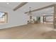 Bright living room with wood floors, beams, and view to the kitchen at 157 Shadburn Ferry Rd, Buford, GA 30518