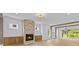 Bright living room with wood floors, fireplace, wood paneling, and beam accents at 157 Shadburn Ferry Rd, Buford, GA 30518