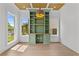 Well-lit home office with custom built-ins, wood floors, and large windows at 157 Shadburn Ferry Rd, Buford, GA 30518