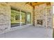 A covered patio features a brick fireplace and large sliding doors opening to a green backyard at 157 Shadburn Ferry Rd, Buford, GA 30518