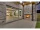 Covered brick patio boasts a fireplace and sliding glass doors opening to the home's interior at 157 Shadburn Ferry Rd, Buford, GA 30518