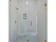 Close-up of a glass-enclosed shower with bronze hardware and mosaic tile accents at 157 Shadburn Ferry Rd, Buford, GA 30518