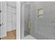Gray tiled shower with gold hardware and custom shelving at 157 Shadburn Ferry Rd, Buford, GA 30518