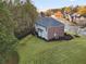 Aerial back of home features a neatly manicured lawn, lush trees, and a private backyard at 3224 Wolf Club Sw Ln, Atlanta, GA 30349