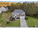 Aerial view of a two-story brick home with a two-car garage and well-maintained landscaping at 3224 Wolf Club Sw Ln, Atlanta, GA 30349