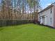 Expansive backyard featuring a lush green lawn and a patio area with views of mature trees at 3224 Wolf Club Sw Ln, Atlanta, GA 30349
