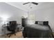 Modern bedroom with a black bed frame, desk, and neutral decor, providing a sleek and comfortable space at 3224 Wolf Club Sw Ln, Atlanta, GA 30349