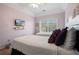 Cozy bedroom with two twin beds, a ceiling fan, and ample natural light creating a comfortable retreat at 3224 Wolf Club Sw Ln, Atlanta, GA 30349