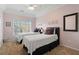 Bright bedroom with two beds and ample natural light, offering a comfortable and inviting atmosphere at 3224 Wolf Club Sw Ln, Atlanta, GA 30349