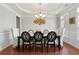 Stylish dining room with a modern chandelier, ample seating, and large windows, creating a welcoming atmosphere at 3224 Wolf Club Sw Ln, Atlanta, GA 30349