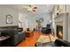 Inviting living room boasts a fireplace, hardwood floors, and comfortable leather seating at 3224 Wolf Club Sw Ln, Atlanta, GA 30349