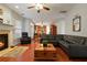 Cozy living room features a fireplace, hardwood floors, neutral paint, and comfortable leather furniture at 3224 Wolf Club Sw Ln, Atlanta, GA 30349