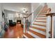 Inviting living room features hardwood floors, a cozy fireplace, and a staircase, blending warmth and functionality at 3224 Wolf Club Sw Ln, Atlanta, GA 30349