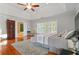 Bright main bedroom featuring hardwood floors and an ensuite bathroom with a soaking tub at 3224 Wolf Club Sw Ln, Atlanta, GA 30349