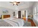 Bright main bedroom featuring a tray ceiling, hardwood floors, and access to an ensuite bathroom at 3224 Wolf Club Sw Ln, Atlanta, GA 30349
