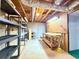 Unfinished basement with shelves, workbench, and exposed ceiling at 8710 Mount Rushmore Dr, Johns Creek, GA 30022