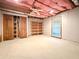 Unfinished basement featuring wooden shelving and drop ceiling at 8710 Mount Rushmore Dr, Johns Creek, GA 30022