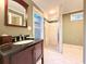 Modern bathroom features vanity, granite countertop, and enclosed tiled shower at 8710 Mount Rushmore Dr, Johns Creek, GA 30022